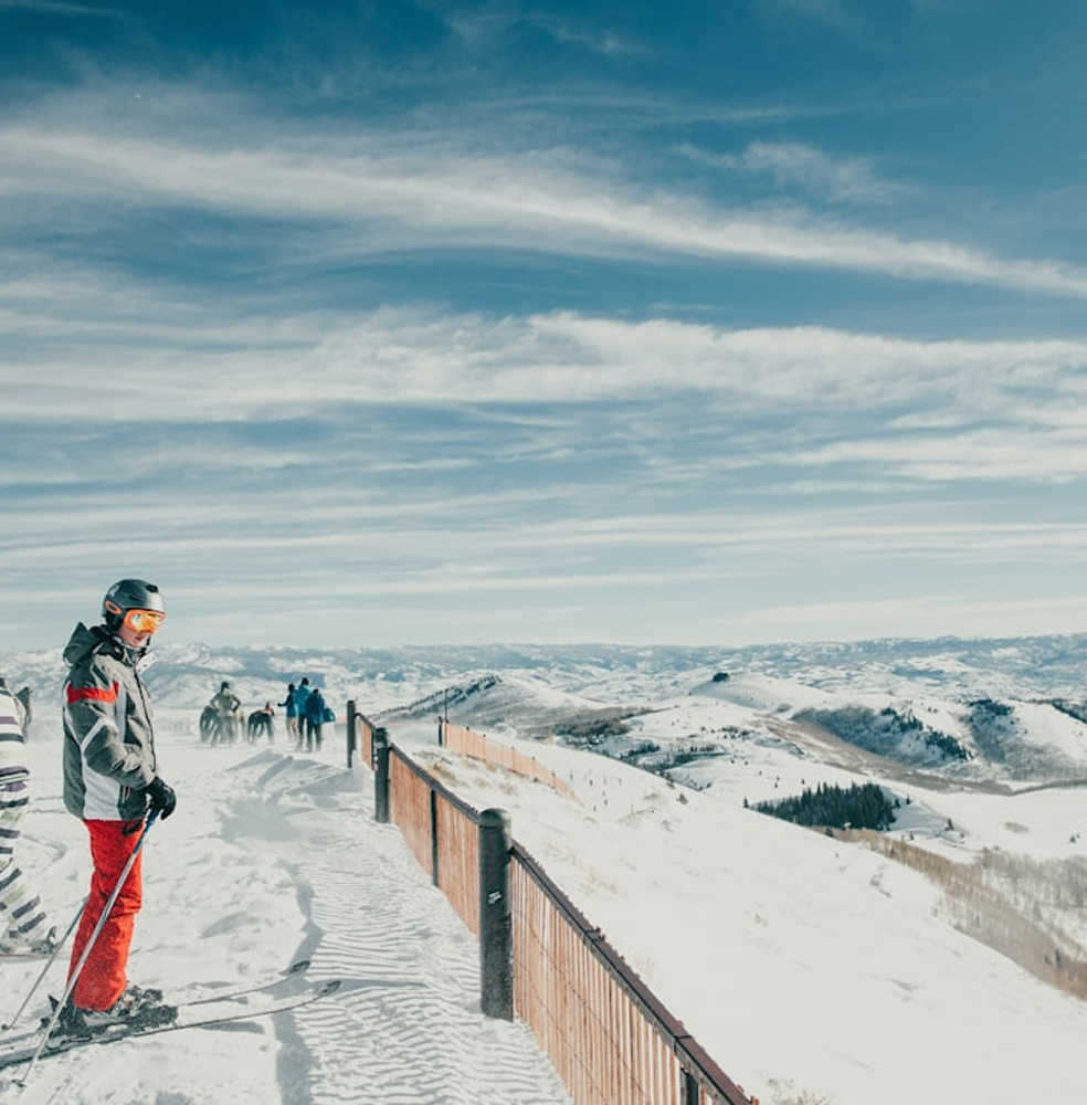A skier looking down on a mountain, probably in Utah